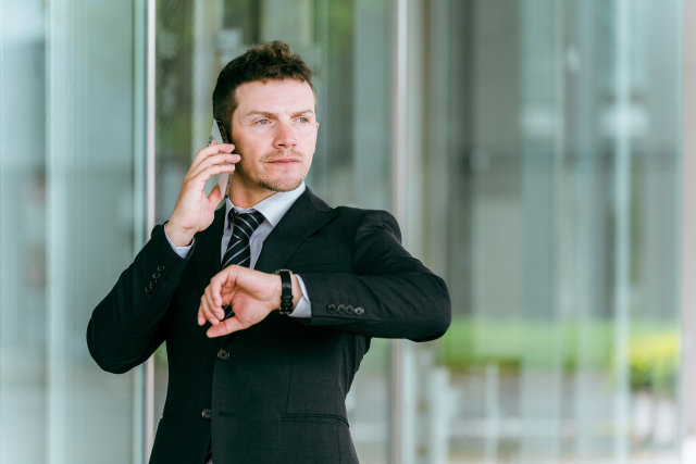 時計をちらっとみる外国人男性